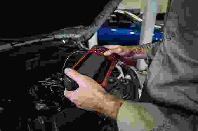 Mechanic Using A Diagnostic Tool On A Car An To Motor Car Servicing For Beginners : With Practical Exercises